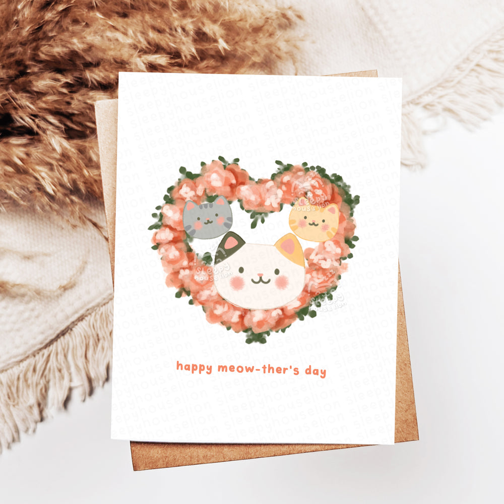 Greeting card with cat-themed wreath and text 'happy meow-ther's day'.