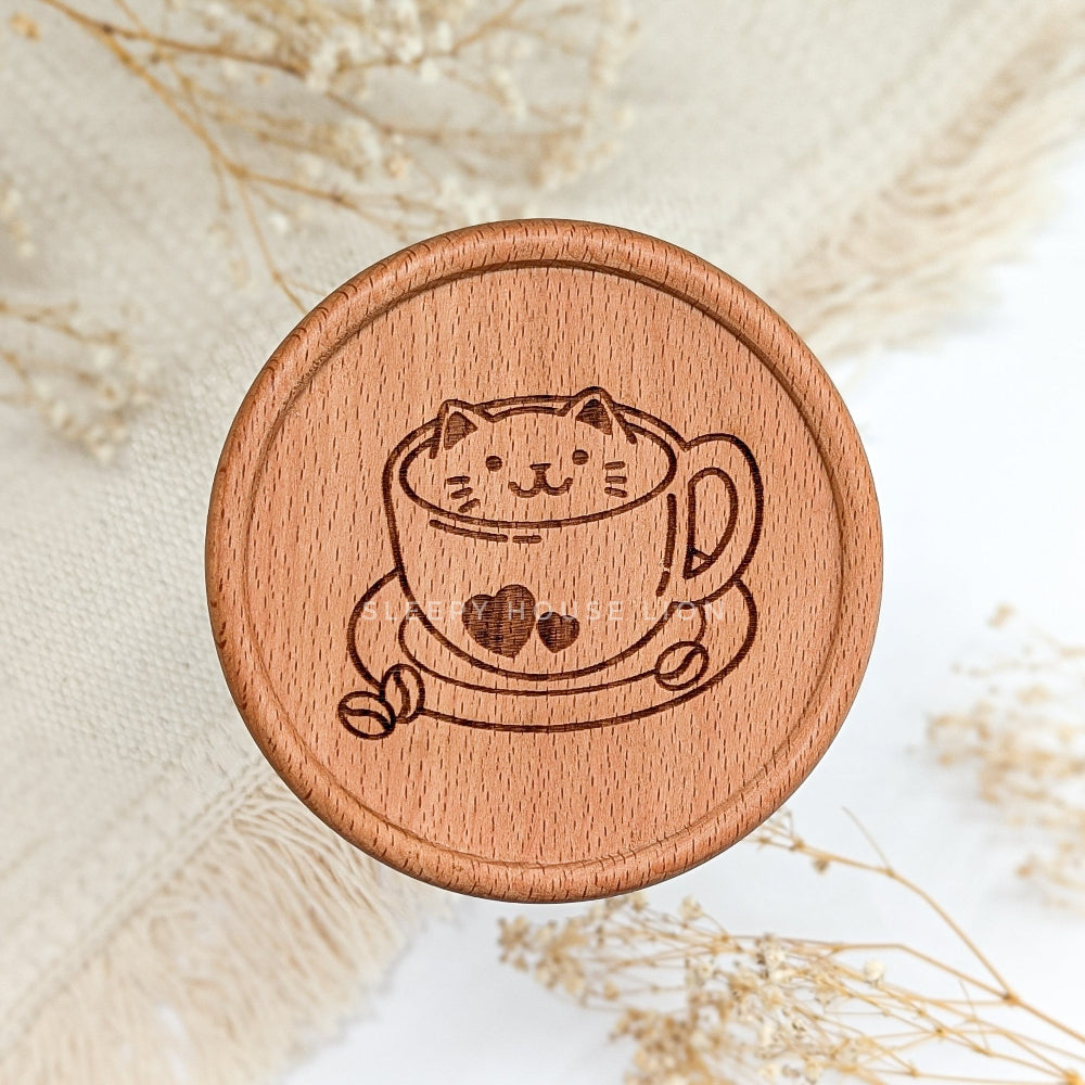 Wooden coaster with a cat design in a teacup on a light background