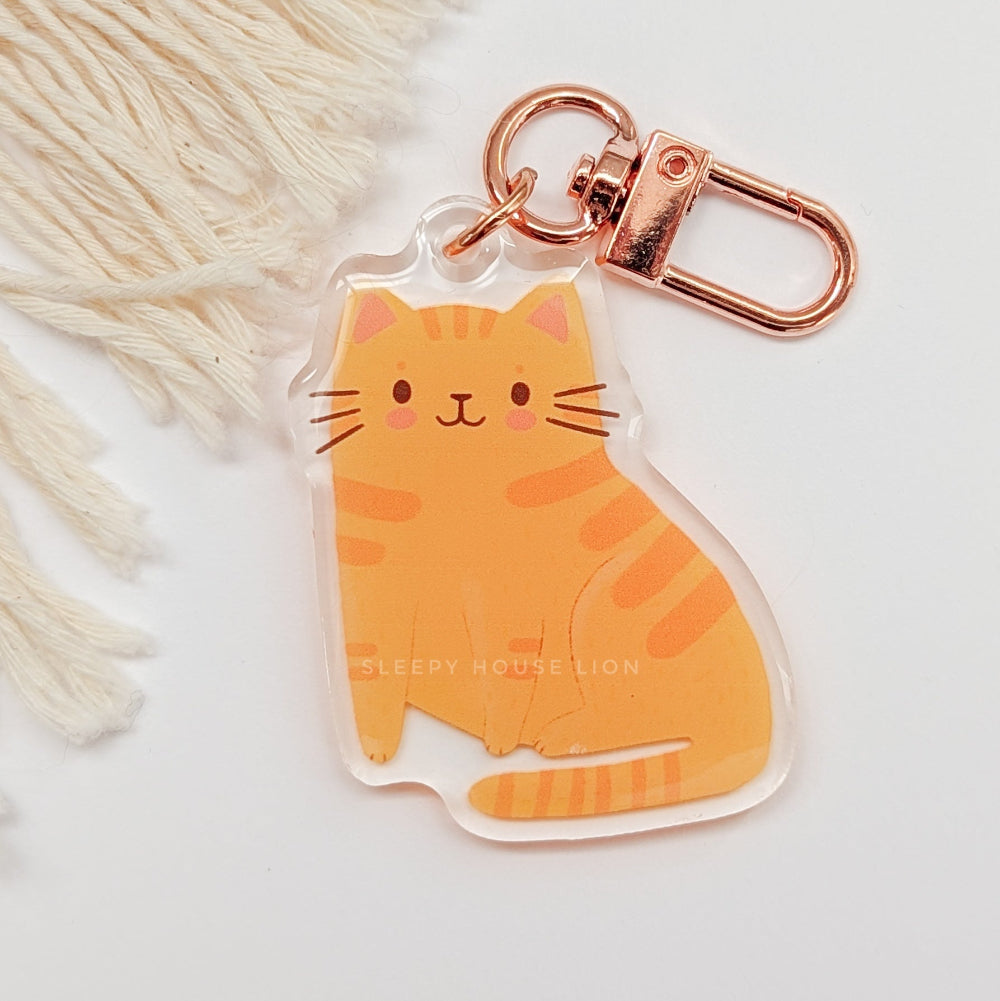 Cat-shaped keychain with rose gold clasp on a white background