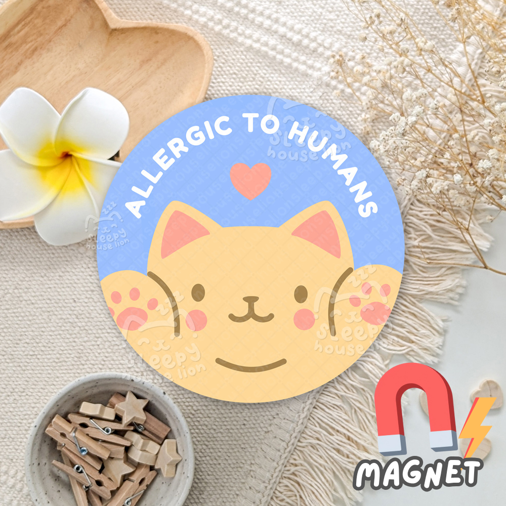 Cat-shaped magnet with 'Allergic to Humans' text on a decorative background