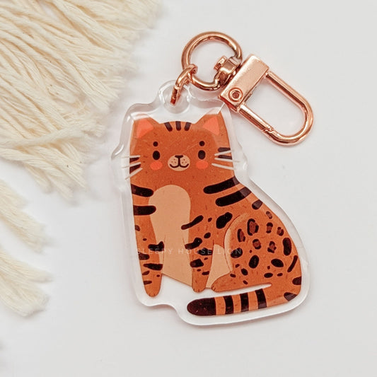 Cat-shaped keychain with rose gold clasp on a light background