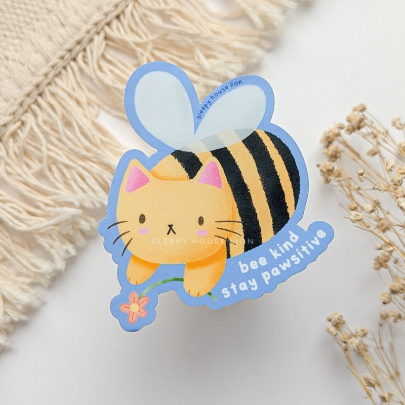 cat shaped like a bee holding a flower vinyl sticker