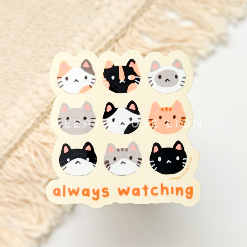 cat heads vinyl sticker with text "always watching"