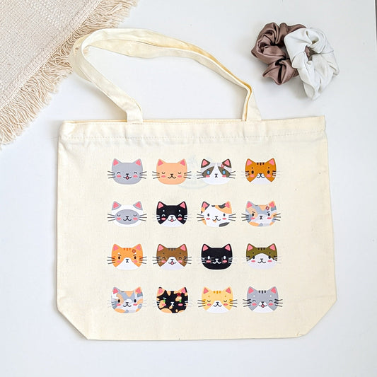 Tote bag with cat illustrations on a light background