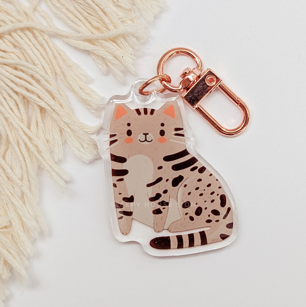 Cat-shaped keychain with rose gold clasp on a white background