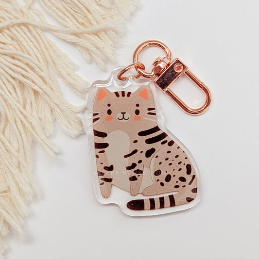 Cat-shaped keychain with rose gold clasp on a white background
