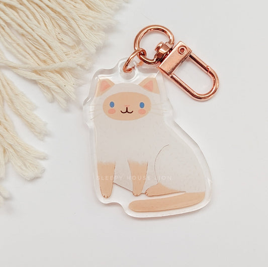 Keychain with a cute cat design on a light background