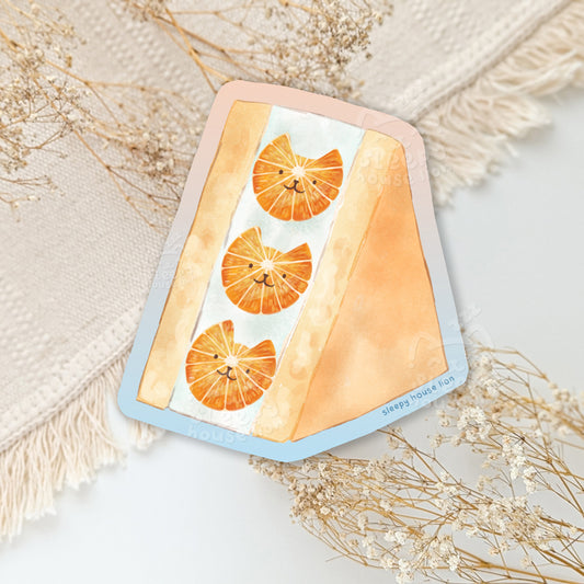 Orange slices in the shape of cat heads in a fruit sandwich