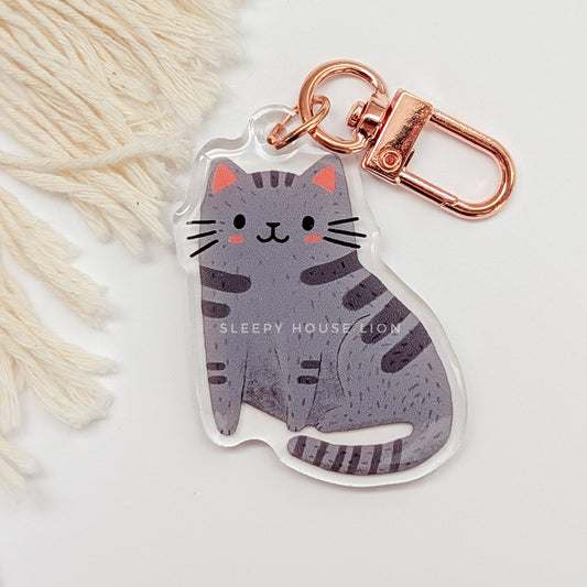 Cat-shaped keychain with rose gold clasp on a light background
