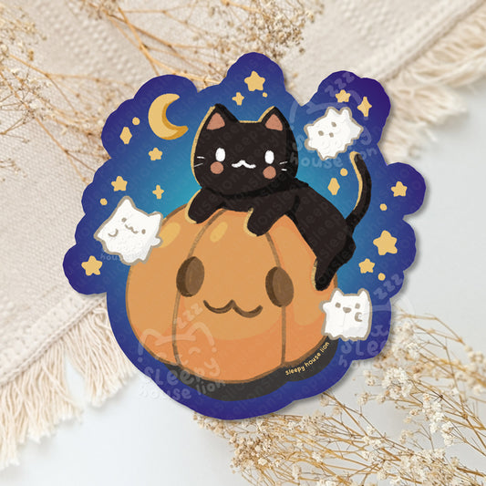 Sticker with a black cat on a pumpkin against a starry night sky.