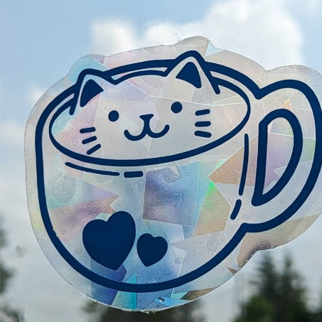 Holographic cat in a mug window sticker and window cling with blurred background