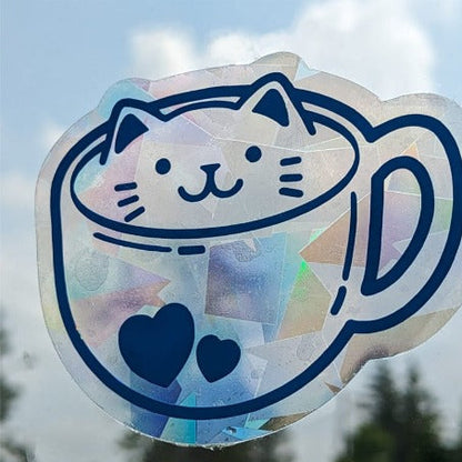 Holographic cat in a mug window sticker and window cling with blurred background