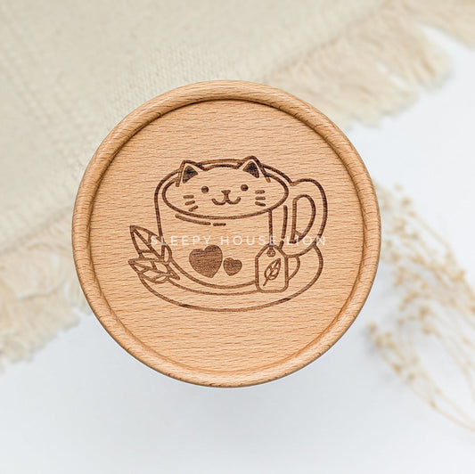 Wooden coaster with a cat design on a light background