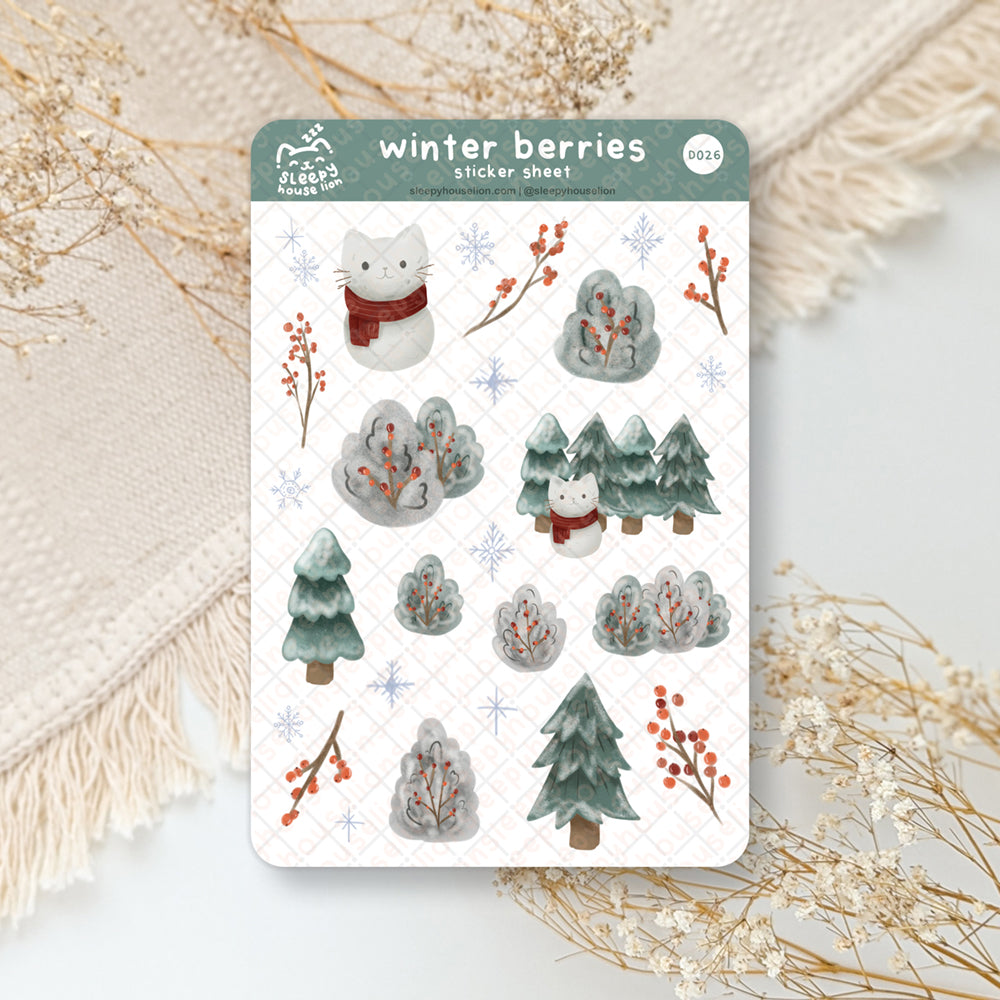 winter themed sticker sheet with red berries and frosty bushes and a cat snowman